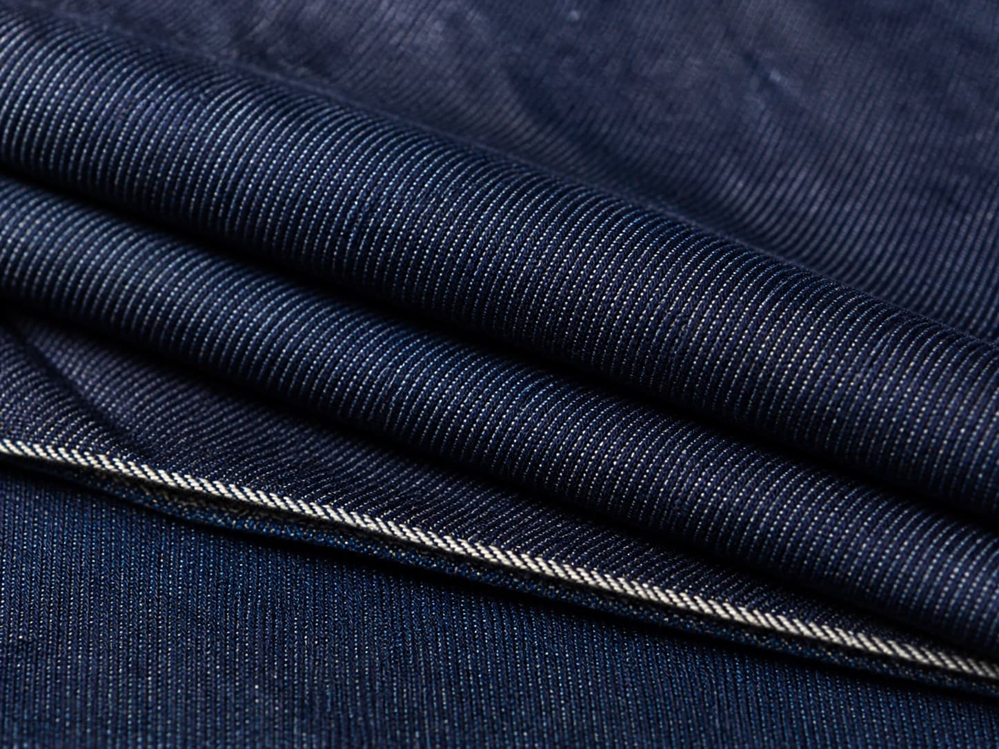 Close-up of deep indigo denim with a diagonal twill weave