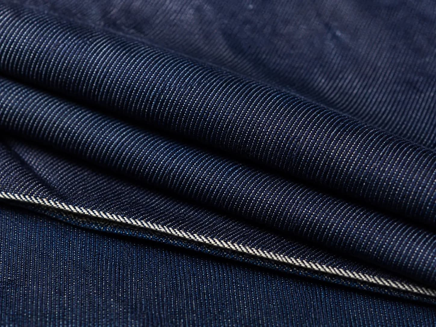 Close-up of deep indigo denim with a diagonal twill weave