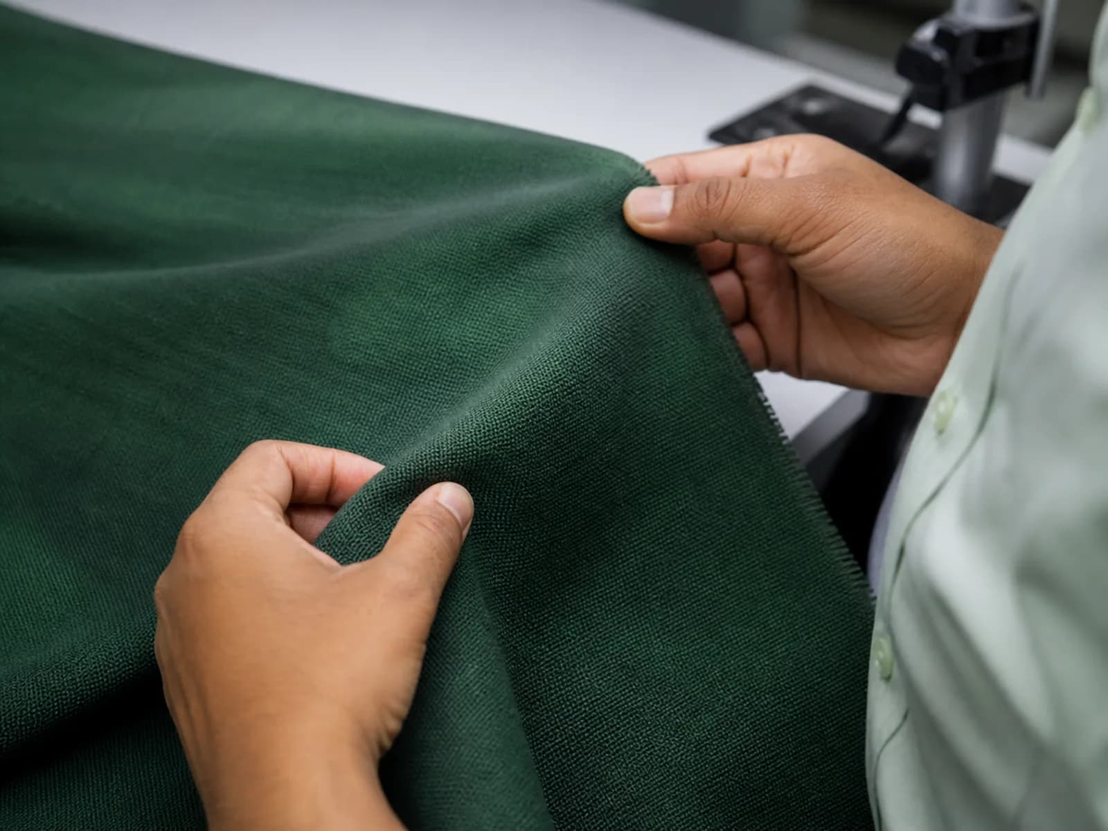Technician inspecting the weave and shade consistency of dyed fabric